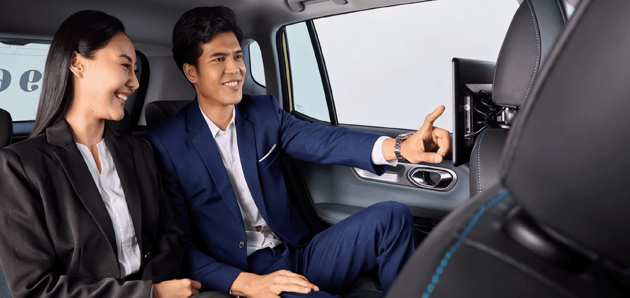 Business passengers watching a MotionReach in-taxi digital screen