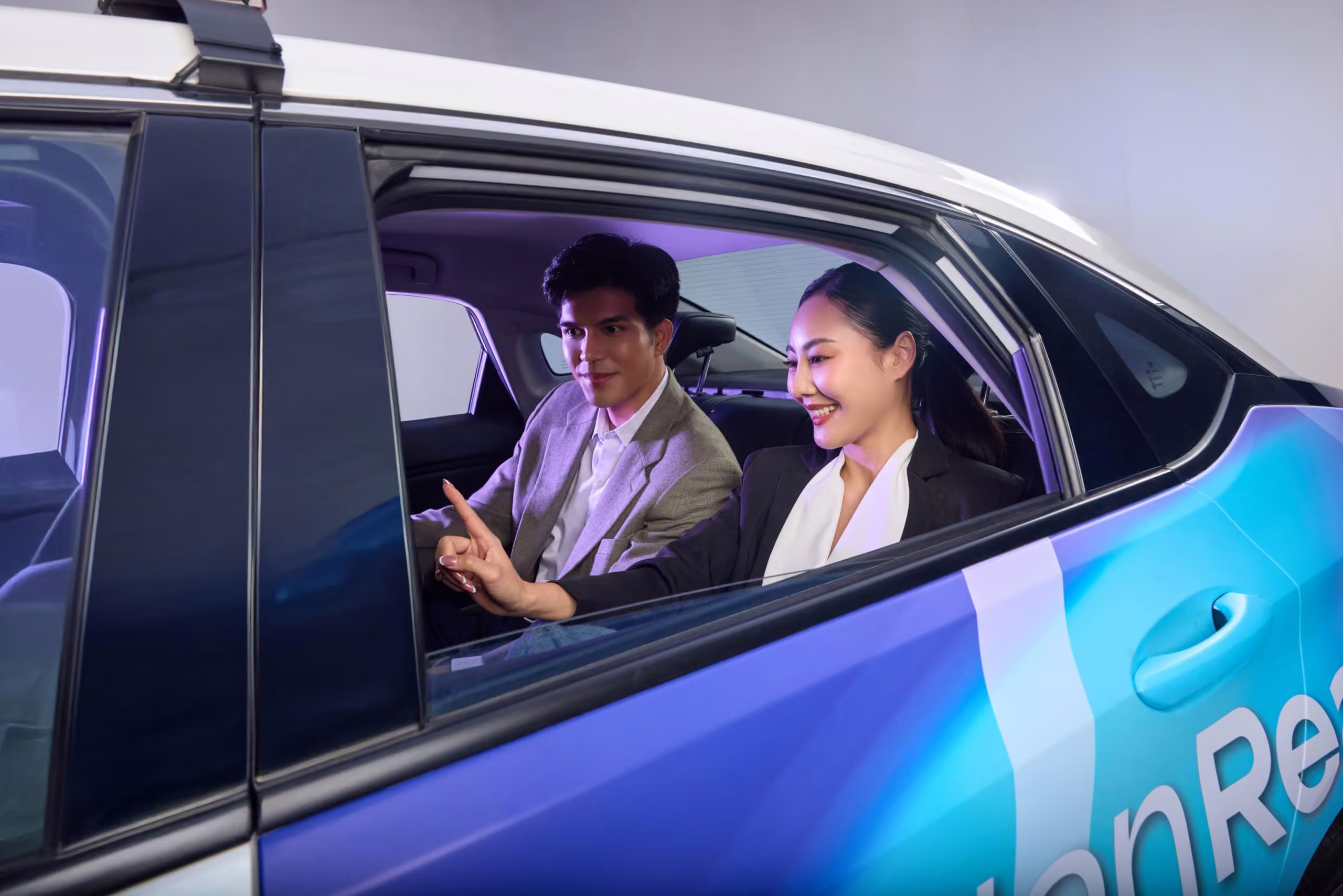 Passengers viewing a digital screen inside a MotionReach taxi
