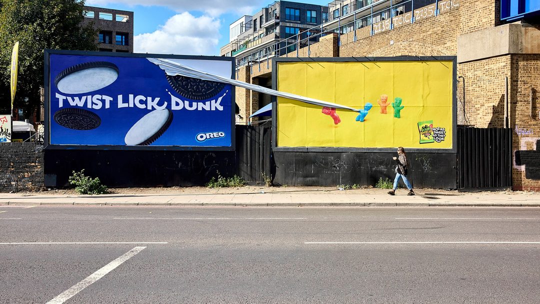 Sour Patch Kids special build billboard pulling the neighbouring OREO poster off, a creative billboard in London